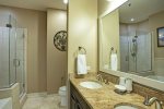 Primary en suite has glass walk-in shower, bathtub, and dual sinks. 